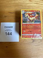 Photo of Pokémon card with Rapidash artwork and number 144 label for identification.
