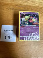 Front view of a sealed stack of Pokémon cards showing a Comfey card on top.