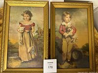Photo showing the set of two framed vintage Jane Freeman prints featuring a girl and a boy each holding a dog.