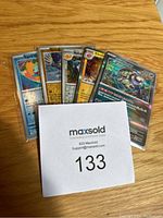 Front view of six Pokémon cards partially visible, showing mixed English and Japanese language cards including Squirtle and other Pokémon with holographic finish on some cards.