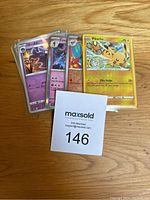 Front view of a portion of the Pokémon cards in protective sleeves, showing a Pikachu card and several Japanese cards.