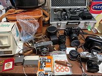 Overview of all cameras, lenses, cases and accessories on table