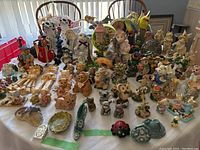 Wide view showing entire collection on table with two chairs behind