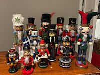 Group of eleven nutcracker figures arranged on wooden surface