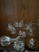 Overview of all 13 figurines displayed on glass shelf