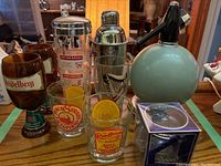 Photo showing entire set with soda syphon, cocktail shaker, and various glasses