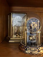 Front view showing both clocks on shelf