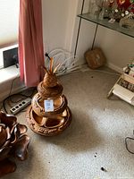 Photo showing the full wooden three tier lazy Susan with pineapple top and 4 removable bowls on bottom tier.