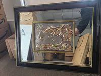 Full view of the Italian Florentine mirror showing the entire decorated mirror with black border and 3D embossed silver sailing scenery artwork in the center.