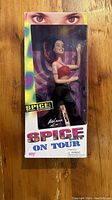 Front view of box with Melanie C Sporty Spice doll visible inside packaging.