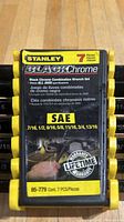 Closeup photo of Stanley 7-piece Black Chrome combination wrench set label showing sizes and product details.
