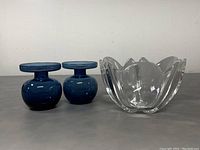 Front view of the two blue glass vases and the clear Orrefors crystal tulip bowl showing size, shape and color details.