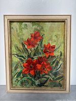 Full view of the framed 20x24 inch oil painting depicting red flowers on green foliage.