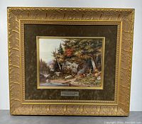 Front view of framed art reproduction, gold ornate frame, brown mat, and artwork centered with plaque beneath.
