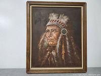 Front view of the framed painting showing the Native American Indian chief with a feathered headdress, signed by J. Hawkins on the lower right.