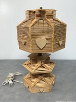Front view of the vintage popsicle stick table lamp showing hexagonal shape and heart motifs.