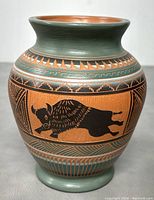Front side of the Native American pottery vase showing buffalo motif and detailed band designs.