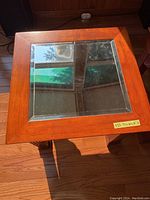 Top view of the wooden end table showing the glass inset top with four glass sections and wooden frame.