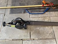 Top view of the entire black Toro leaf blower showing handle, blower tube, and power cord.