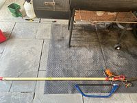 Full view of both tools showing pole saw and bow saw laid out parallel on floor