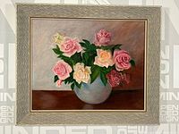 Full view of oil on board floral painting depicting pink, white, yellow, and red roses in a white vase on a brown surface with detailed frame.