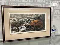 Framed print showing the full artwork with a fox lying on a forest floor with snow patches. Includes water bottle for scale.
