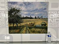 Full view of the signed oil on canvas painting depicting a farm scene with large tree, cattle pulling a hay cart, fields and cloudy sky, with a water bottle beside painting for size reference.