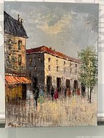 Full view of the oil painting showing urban scene with buildings, several figures, tree, and cloudy sky, signed in lower left corner.
