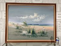 Frontal view of the framed seascape painting against studio wall