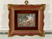 Full view of framed painting depicting two figures in a pastoral scene with ornamental frame