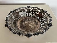 Angled top view showing overall basket shape, pierced sides, and scalloped rim