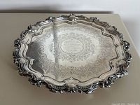 Top view showing full circular tray with ornate boundary and central inscription