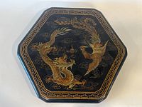 Hexagonal closed game board case with detailed dragon and phoenix decoration on the lid.