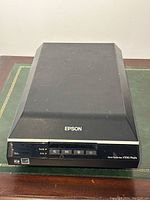 Front view of Epson Perfection V550 Photo scanner showing brand, model and control panel.