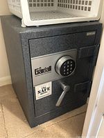 Overall front view of safe positioned under shelving