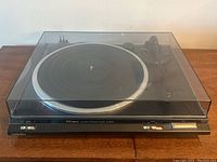 Front view of Technics SL-BD20D Automatic Turntable with closed dust cover, showing control buttons and dust cover hinge area