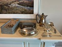 Full lot display showing teapot, covered dishes, and cutlery box
