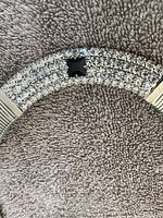 Close-up of front section of necklace showing three rows of clear rhinestones and a central black square stone set on silver-tone metal base.