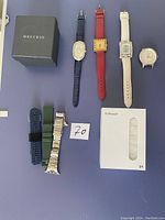 Lot of four watches, five watch bands including silicone, leather, and metal, a MREURIO boxed watch and white watch band packaging.