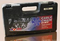 Black plastic carrying case with handle and SCC Cable Chain label on front