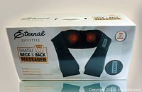 Front view of the Eternal Lifestyle Shiatsu Neck & Back Massager box showing the product image and branding, highlights heat feature and massage function.