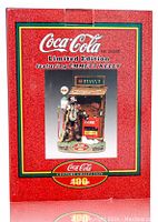 Front of the box showing Coca-Cola branding and image of Emmett Kelly figurine
