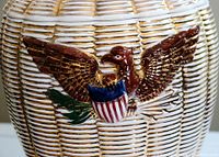 Close-up of the eagle emblem on the textured ceramic cookie jar lid showing detailed paint and raised relief.
