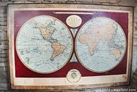 Full front view of the vintage double hemisphere world map print on canvas with reddish-brown border.