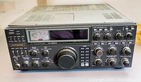 Front angled view of Kenwood TS-930S transceiver showing overall unit and detached top cover