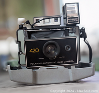 Front view of Polaroid Automatic Land Camera Model 420 folded out showing lens, flash, and controls.