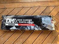 Box with DKM branding and model BCR490 showing bike carrier packing and some damage to box edges.