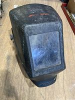Front view of black Jackson welding helmet with visible scratches on the viewing window and 'BOC' branding on top.