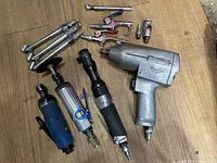 Full layout of all air tools showing Snap-on, PowerFist, and other brand tools on wooden surface