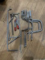 Full view of the set showing 12 specialty mechanics wrenches with varied shapes and lengths, two have red plastic tips.